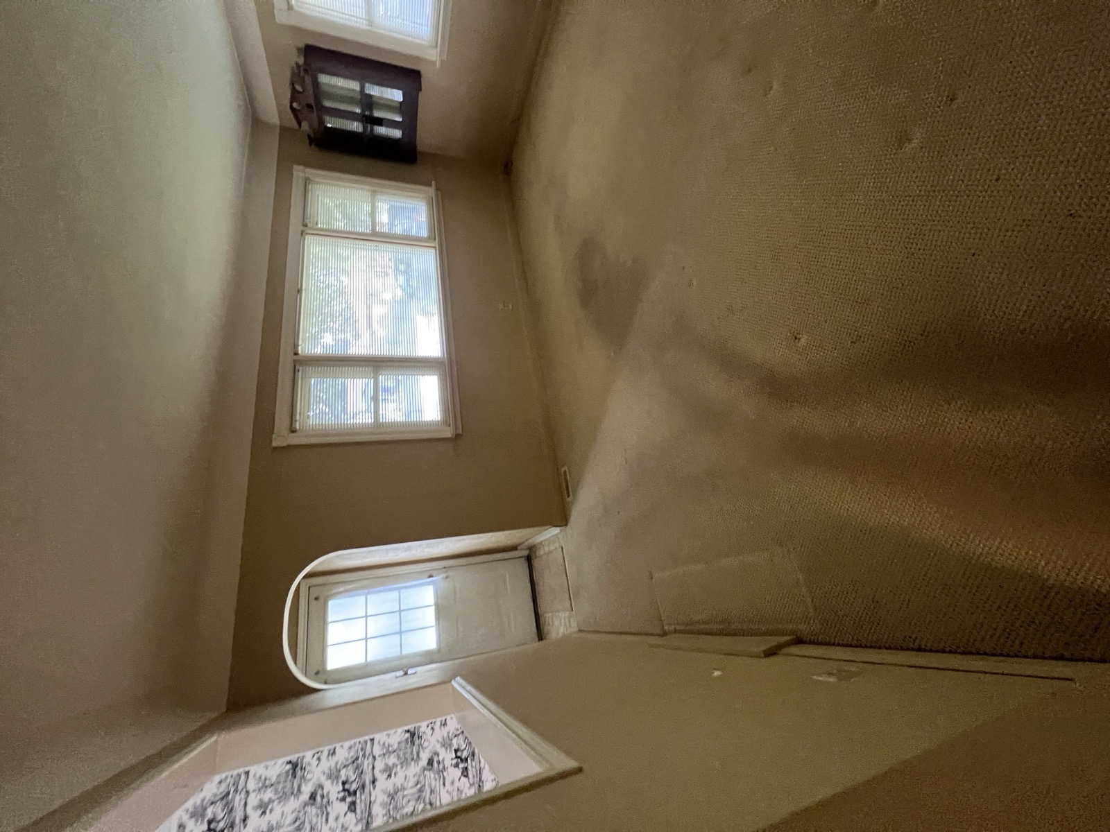 Empty carpeted living room, left exactly as it was found