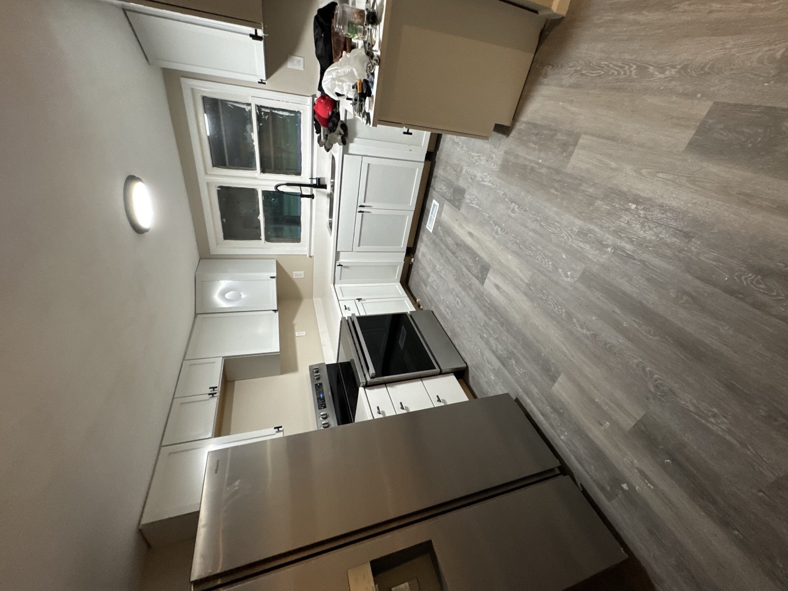 Finished white kitchen with plank flooring